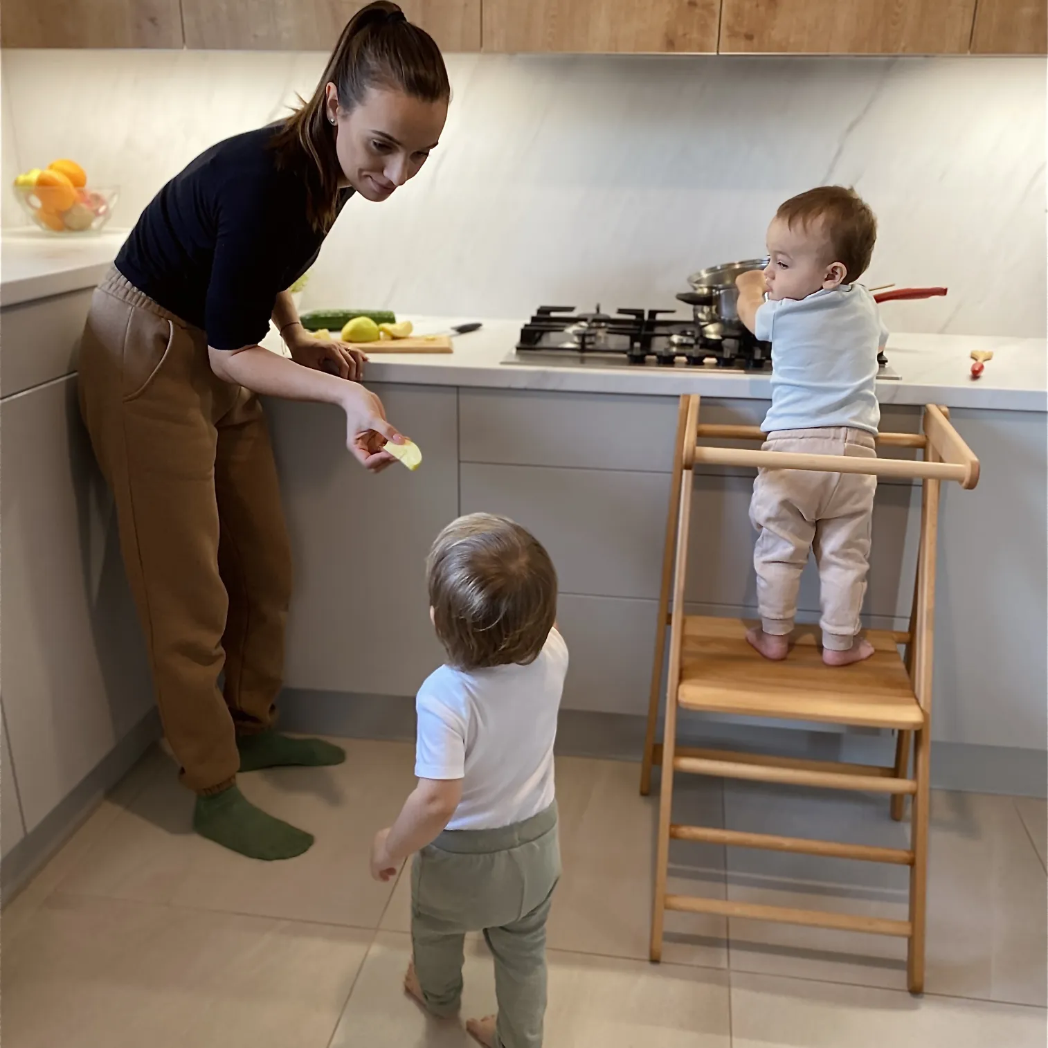 Parent and child cooking together at counter with Foldable MONTEtower helper